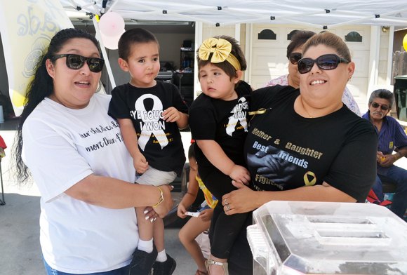 Mom Veronica Araiza and son Michael shared lemonade duties with young Jocelyn Flores and her mother Melissa Flores Saturday as they sold lemonade to help in the fight against cancer.